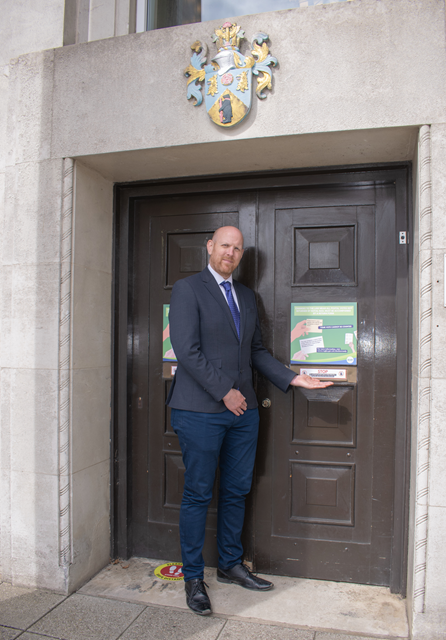 Tom Kittendorf, Deputy Returning Officer for Rugby, with the new signage at the Town Hall, warning voters not to hand-deliver postal votes without completing a return form.