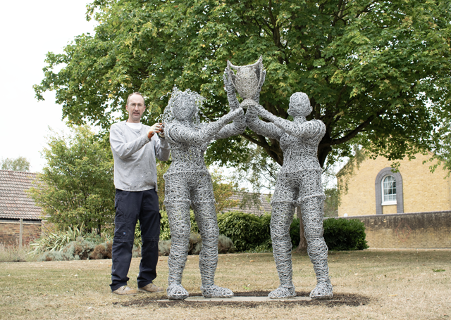 Tony Davies putting the finishing touches to Raising The Trophy, a wire sculpture commissioned by Rugby Borough Council to celebrate the Women's Rugby World Cup.