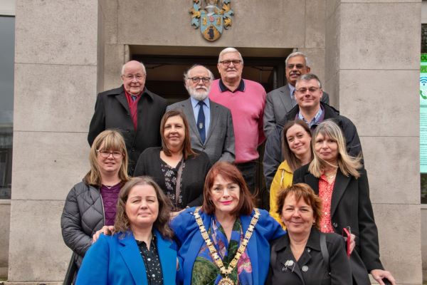 Pictured are volunteers from Rugby Autism Network, families who have been supported by the charity, with Cllr Maggie O’Rourke (front centre), Fay McSorley (front left) and Eric Wood (back left).