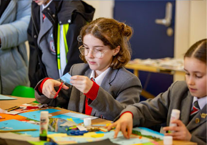 Picture of child cutting and sticking in school